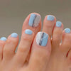 Sky blue and white press-on toenails with black abstract lines – Blue Mist pedicure set from Impress Me Lebanon