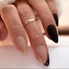 Matte black and nude almond-shaped press-on nails with gold line accents for an elegant and modern style