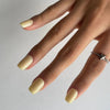 Glossy yellow Lemonade press-on nails in a square shape, perfect for summer