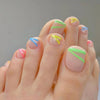 Neon striped press-on toenails in green, blue, pink, and yellow on a clear nude base – Pop Stripes pedicure by Impress Me