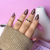 Close-up of Impress Me Toffee Hive giraffe-style press-on nails in Beirut – trendy brown patterned nails for fall